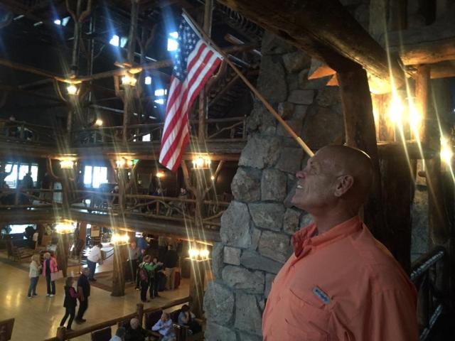 Ken Baxter, Founder of Made In America, next to our American Flag at Old Faithful Inn, Yellowstone National Park, Wyoming, USA